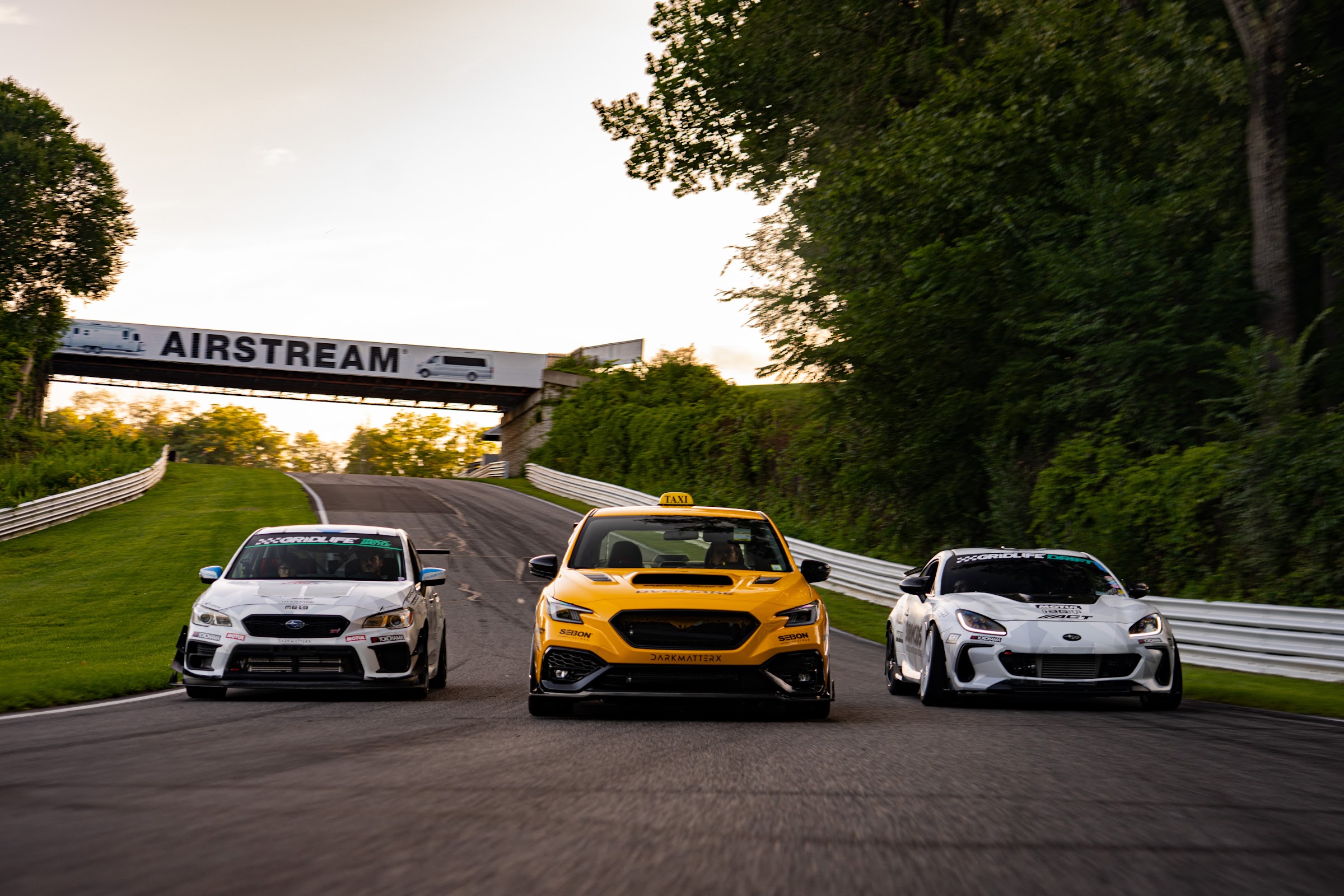 Three-car pack racing under the Airstream bridge