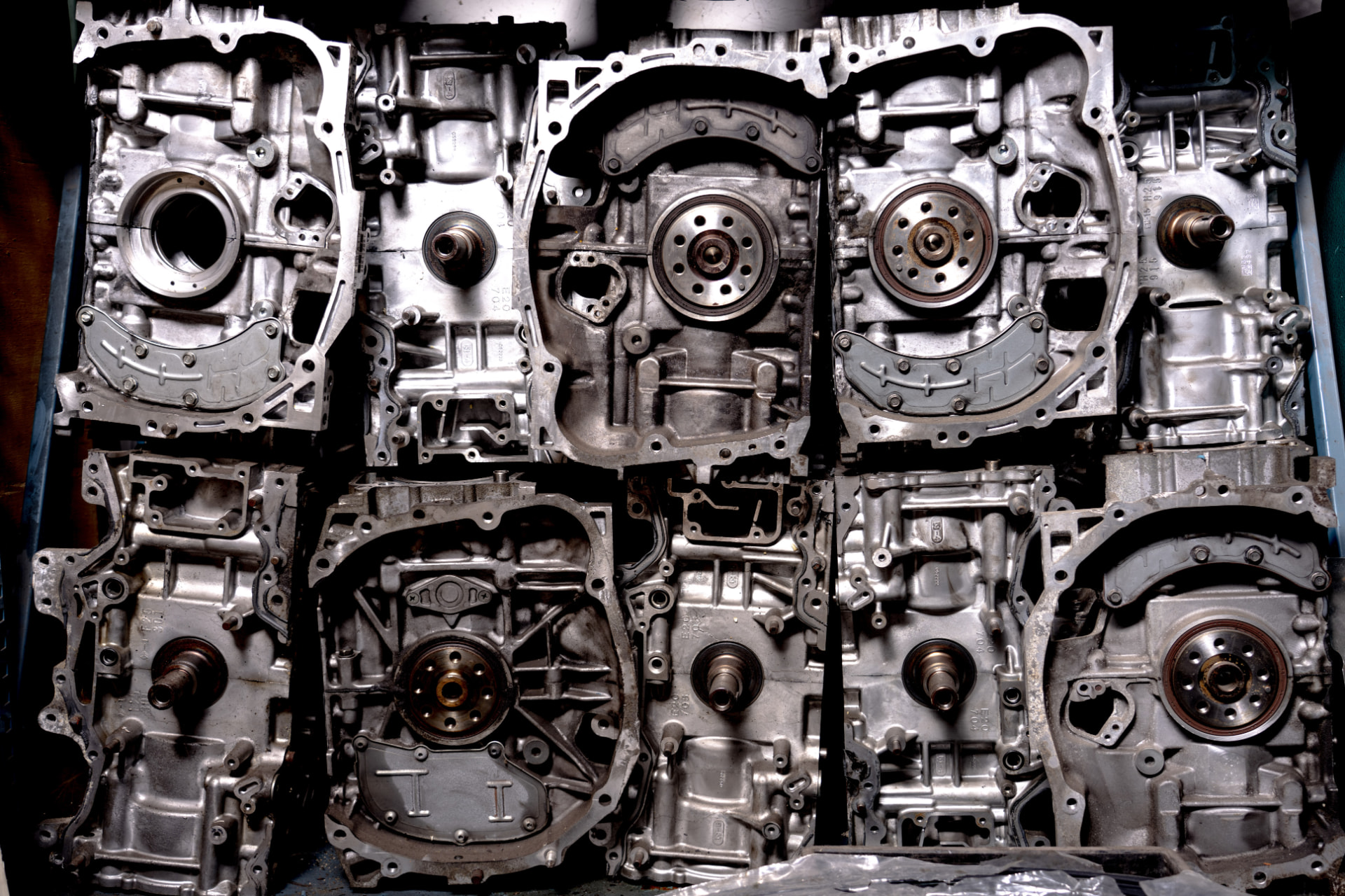 Rows of disassembled boxer engine short blocks lined up in a workshop