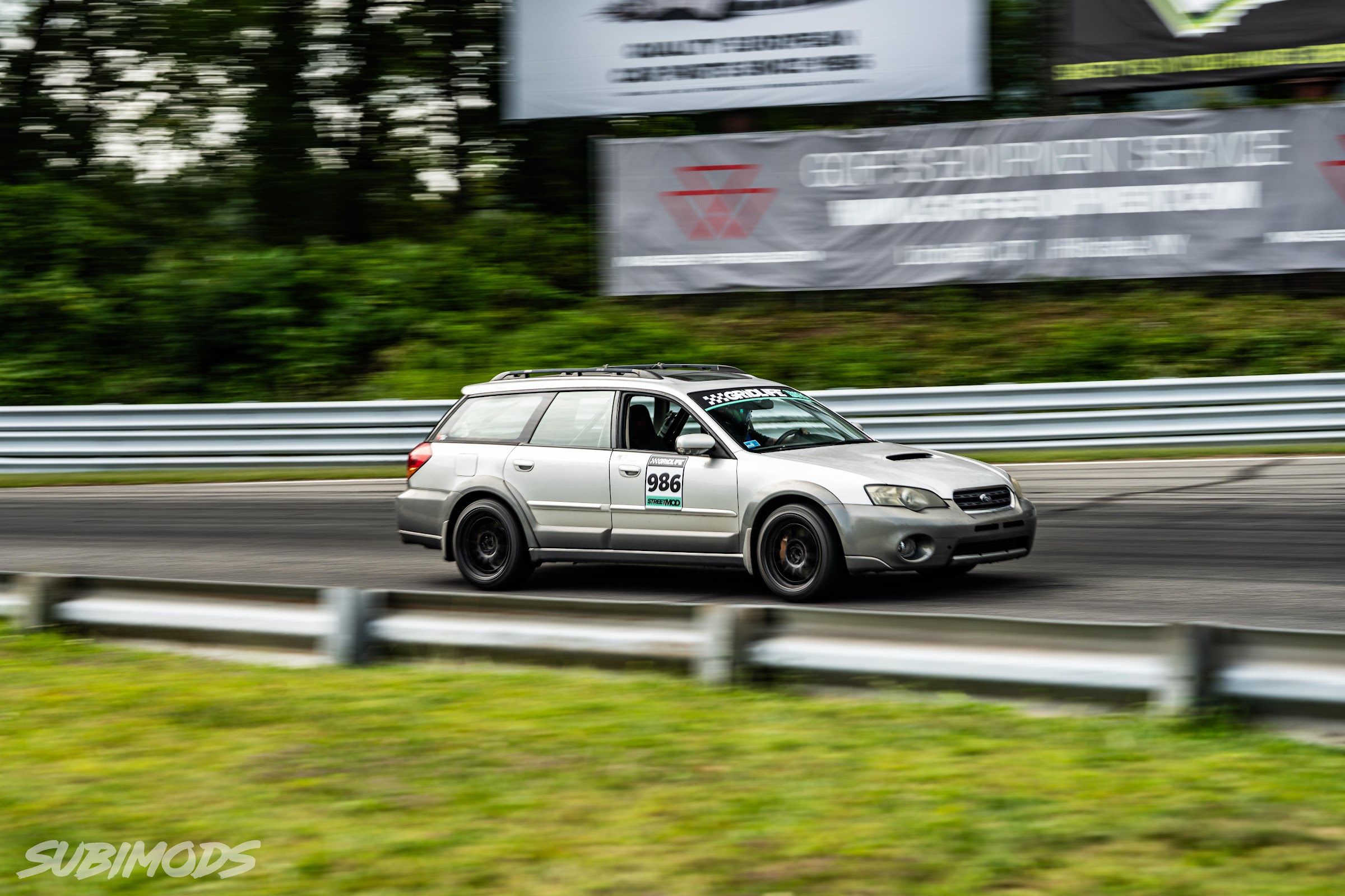 Subaru Outback wagon at speed on the front straight