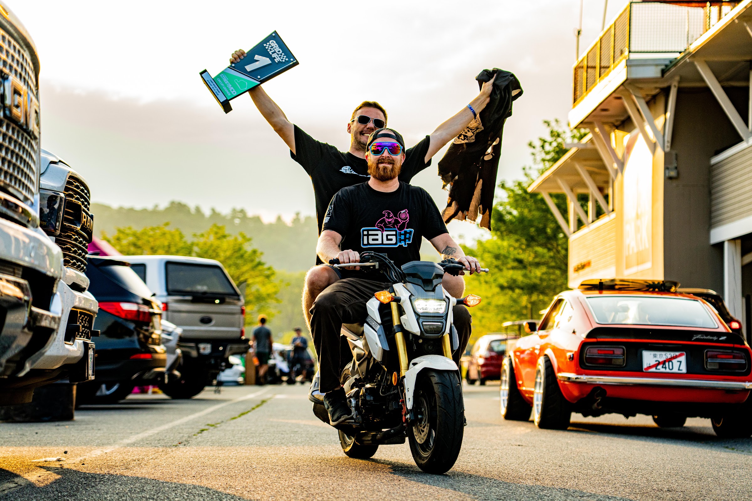 Driver celebrating on a motorcycle in the paddock
