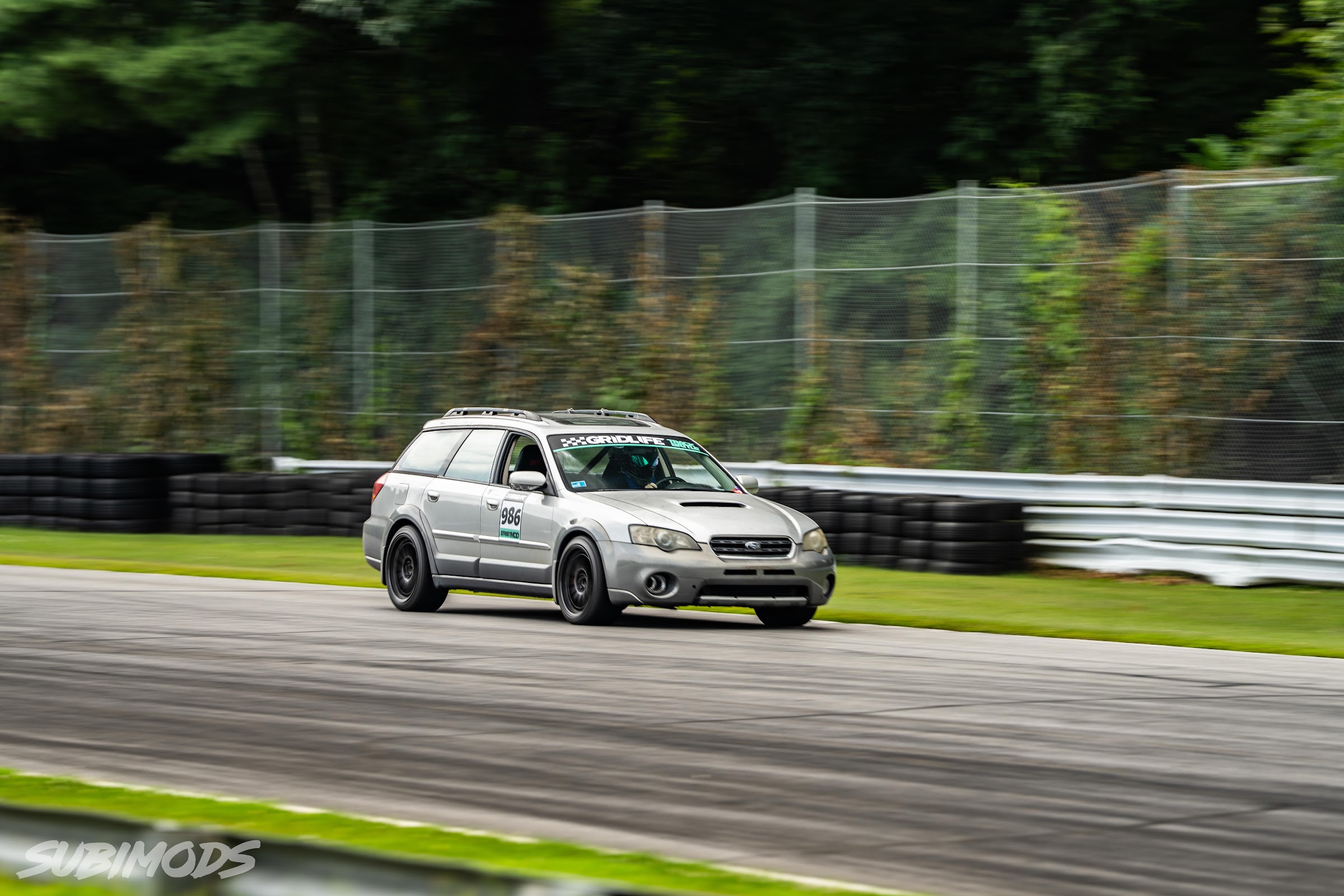 Outback wagon carrying speed past the pit wall